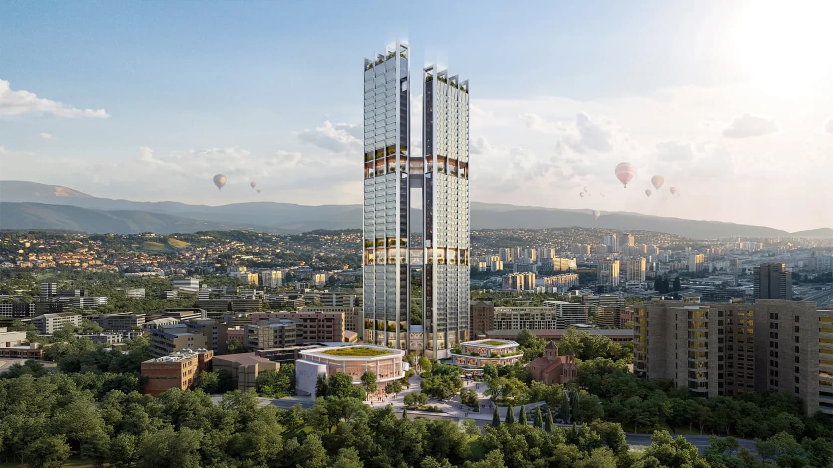 Visualisation des deux tours prévues du WTC Yerevan : deux tours de verre élancées de hauteurs légèrement différentes, reliées par des passerelles fermées, au-dessus de bâtiments bas arrondis, d’une petite église et d’arbres, avec Erevan et les montagnes à l’arrière